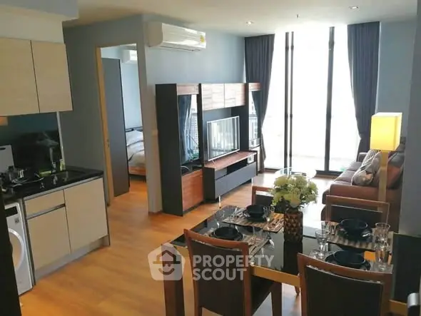 Modern open-plan living room with dining area and kitchen in stylish apartment