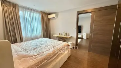 Spacious bedroom with elegant decor and natural light in modern apartment
