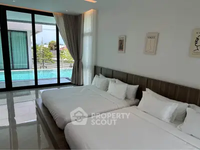 Luxurious bedroom with poolside view and modern decor
