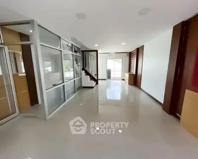 Spacious modern living room with sleek design and large windows for natural light.