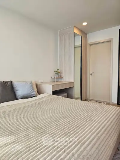 Modern bedroom with cozy bed and stylish wardrobe in a contemporary apartment.
