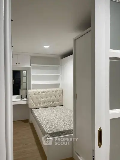 Cozy small bedroom with built-in storage and minimalist design