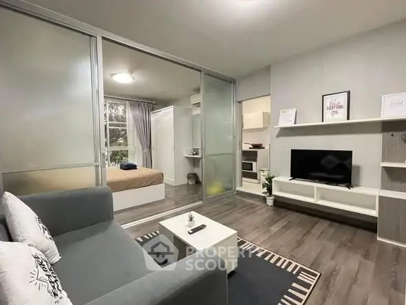 Modern living room with sleek design and cozy bedroom view