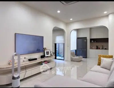 Spacious modern living room with sleek design and open kitchen layout