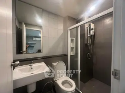 Modern bathroom with sleek shower and contemporary fixtures in a stylish apartment.