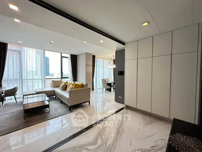 Luxurious open-plan living room with modern furniture and large windows offering stunning city views.