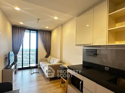 Modern living room with open kitchen and city view balcony in high-rise apartment.
