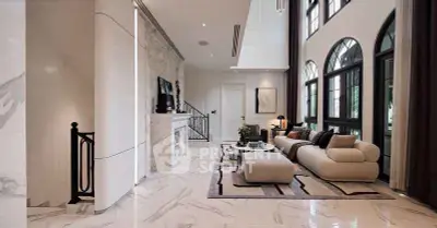 Luxurious modern living room with high ceilings, elegant marble flooring, and stylish furniture.