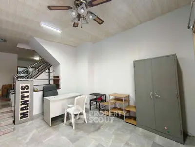 Spacious office space with modern desk, chair, and storage cabinet, ideal for business setup.
