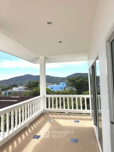 Spacious balcony with stunning mountain views and elegant railing design.