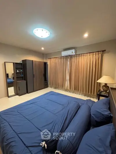 Cozy bedroom with blue bedding and ample closet space