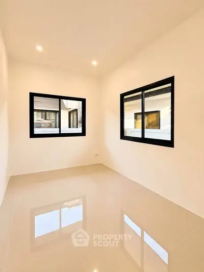 Bright and spacious empty room with large windows and glossy tiled floor, perfect for customization.