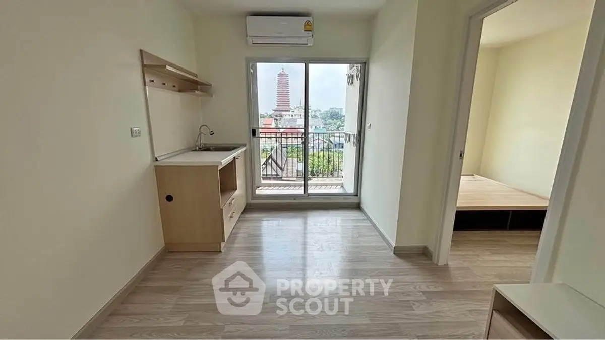 Modern apartment with open layout and balcony view in urban setting