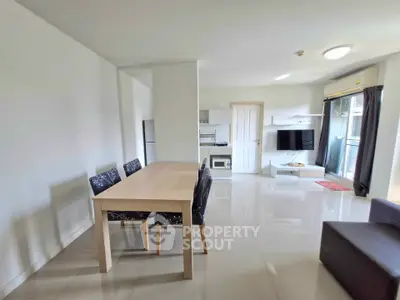 Modern open-plan living room with dining area and balcony access