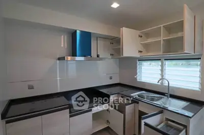 Modern kitchen with sleek cabinets and stainless steel sink