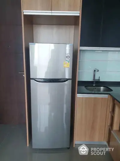 Modern kitchen with sleek fridge and stylish cabinetry