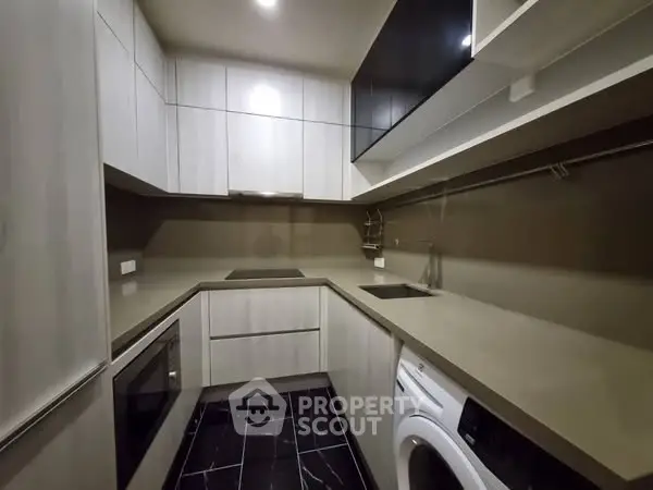 Modern kitchen with sleek cabinetry and built-in appliances