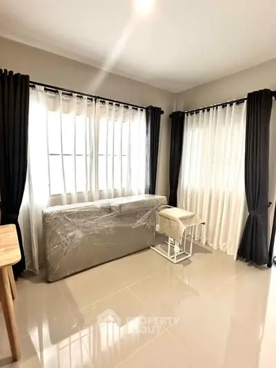 Bright living room with large windows and modern furniture