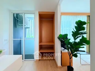 Modern interior with open closet and large window in bright living space
