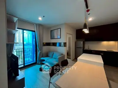 Modern open-layout living room with kitchen, featuring sleek design and city view from balcony.