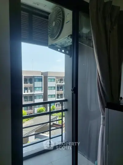 Modern apartment balcony with air conditioning unit and city view