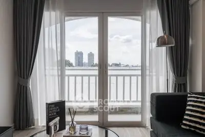 Stylish living room with large windows and city view, featuring modern decor and cozy ambiance.