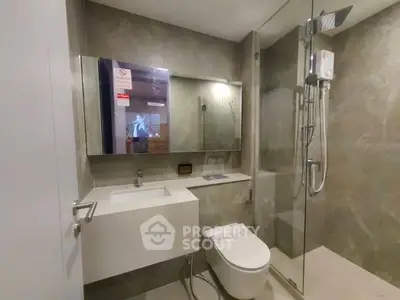 Modern bathroom with sleek fixtures and glass shower enclosure