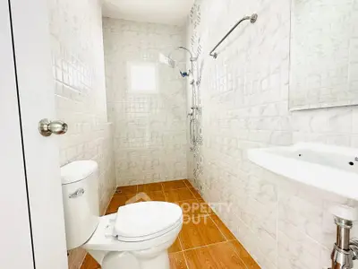 Bright and modern bathroom with sleek fixtures and elegant tile design.