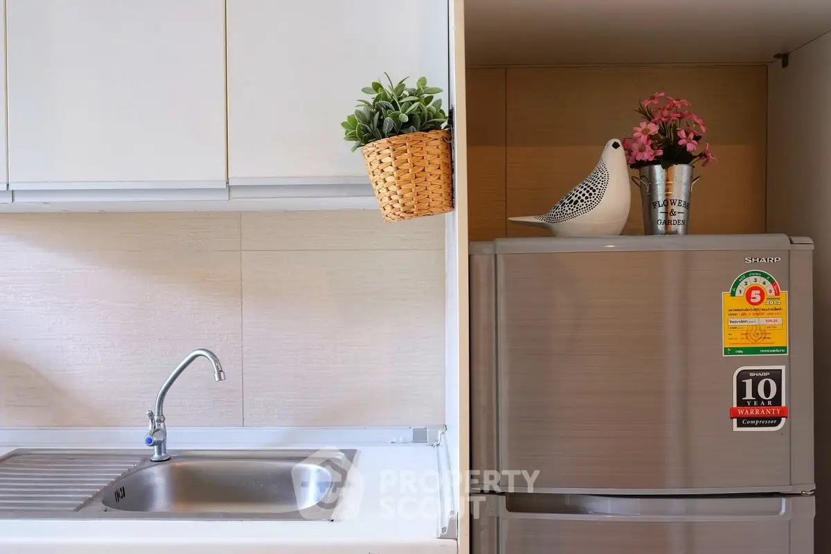 Modern kitchen with sleek fridge and stylish sink area