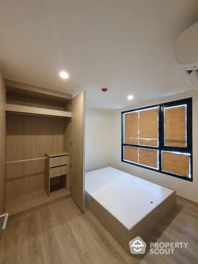 Modern minimalist bedroom with built-in wardrobe and natural light