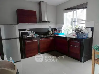 Modern kitchen with dark wood cabinets and stainless steel appliances