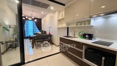 Modern open-layout kitchen and dining area with sleek design and contemporary furnishings.