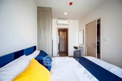 Modern bedroom with stylish decor and air conditioning in a cozy apartment.