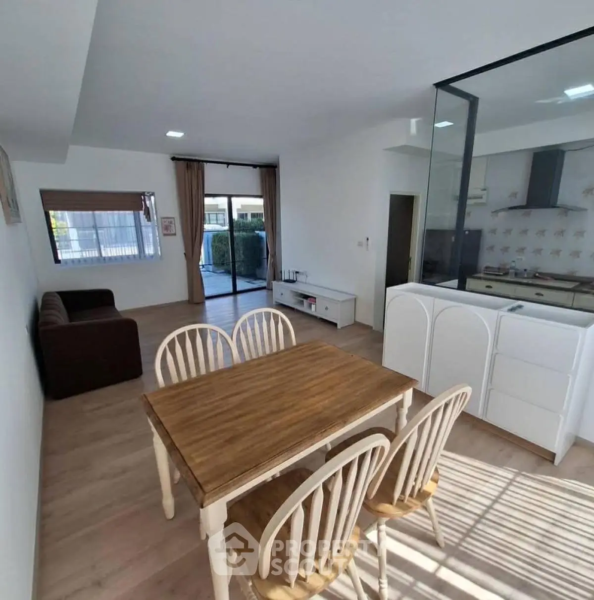 Modern open-plan living and dining area with stylish furniture and natural light.
