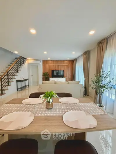 Spacious modern living room with elegant dining area and stylish decor