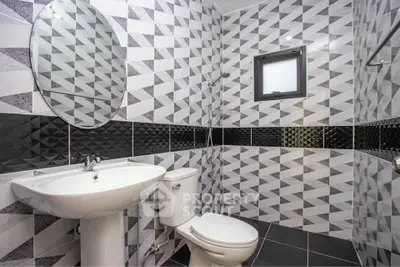 Modern bathroom with geometric tile design and sleek fixtures