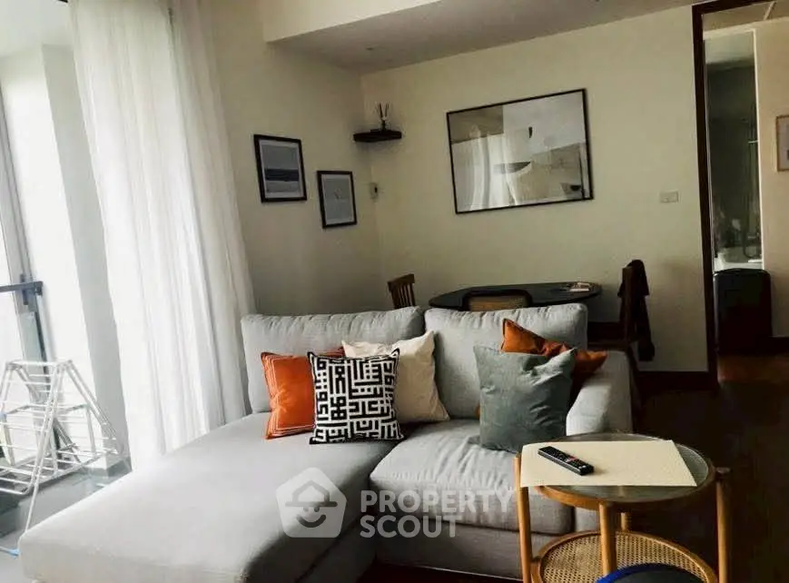 Stylish living room with modern decor and cozy seating in a bright apartment.