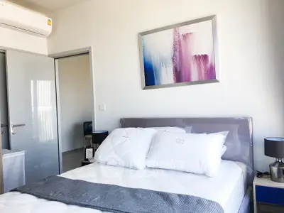 Modern bedroom with stylish decor and air conditioning in a contemporary apartment.