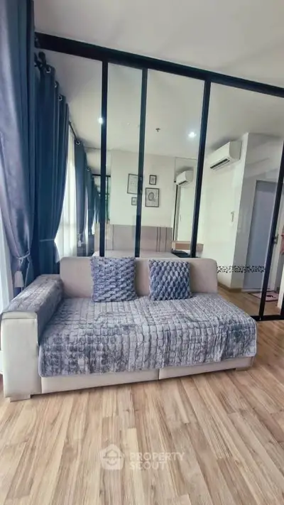 Modern living room with stylish sofa and floor-to-ceiling windows in a chic apartment.