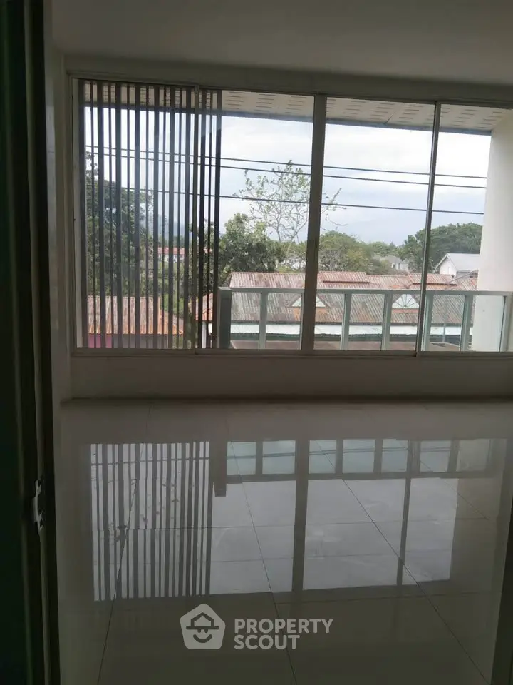 Spacious living room with large windows offering a scenic view, perfect for natural light lovers.