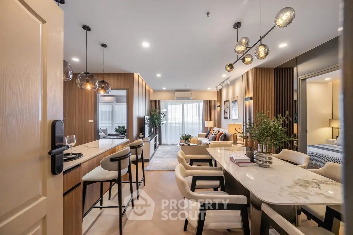 Luxurious modern living room with elegant dining area and stylish lighting fixtures.