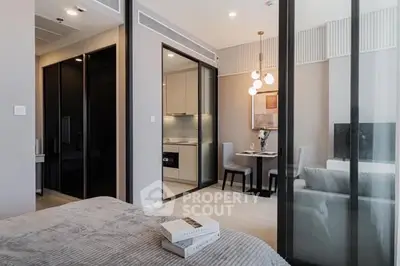Modern apartment interior with open layout, featuring a cozy living area and sleek kitchen design.
