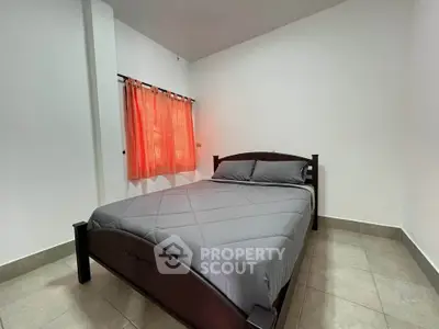 Cozy bedroom with modern bed and vibrant curtains, perfect for relaxation.