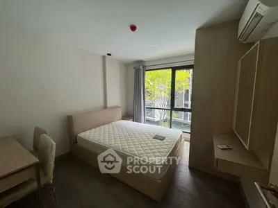 Modern bedroom with large window and minimalist furniture