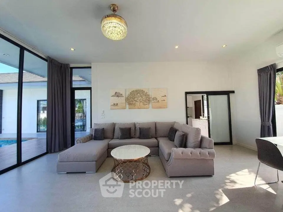 Luxurious modern living room with elegant sofa and pool view
