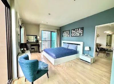 Spacious modern bedroom with balcony and stylish decor in urban apartment