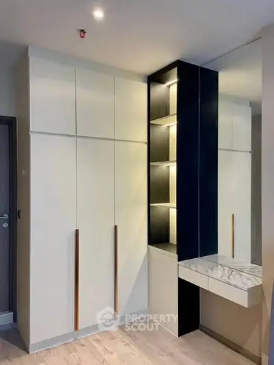 Modern built-in wardrobe with sleek design and integrated lighting