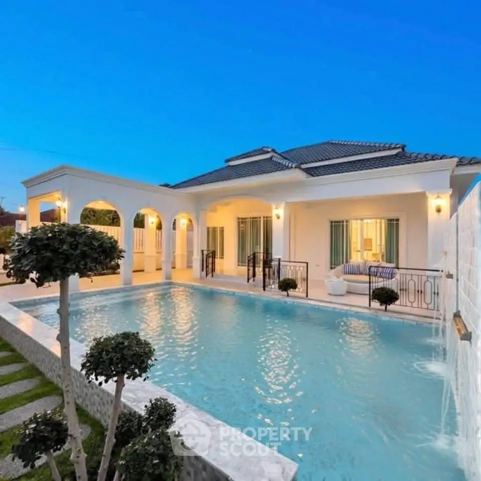 Luxurious villa with stunning pool and elegant architecture at dusk.