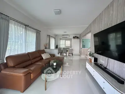 Spacious modern living room with large windows and elegant decor