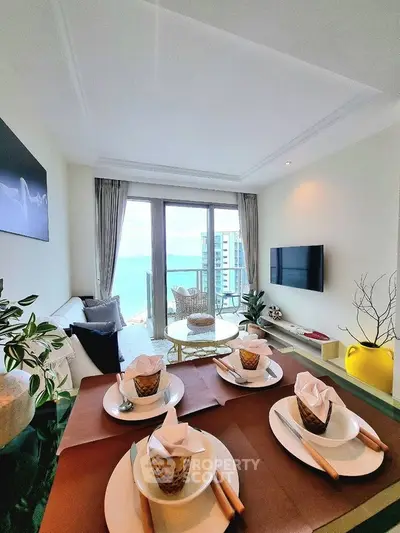 Luxurious living room with ocean view and elegant dining setup